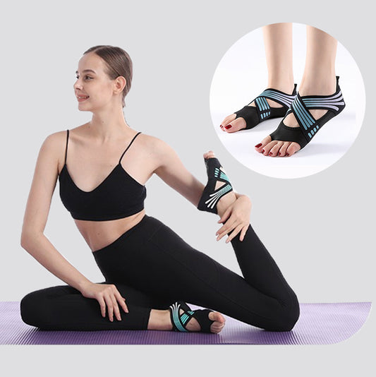 Woman in black sportswear doing yoga on purple mat wearing black and blue open-toe yoga socks